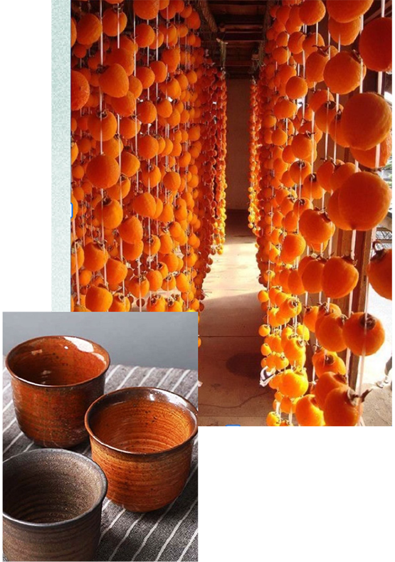 persimmons hanging from strings in a large row, and tall ceramic bowls